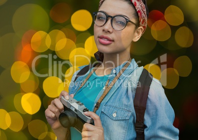 hipster photographer woman with glasses and vintage camera overlap with yellow, green and red blurre