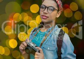 hipster photographer woman with glasses and vintage camera overlap with yellow, green and red blurre