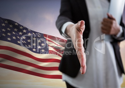 Business woman shaking hands against american flag