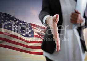 Business woman shaking hands against american flag