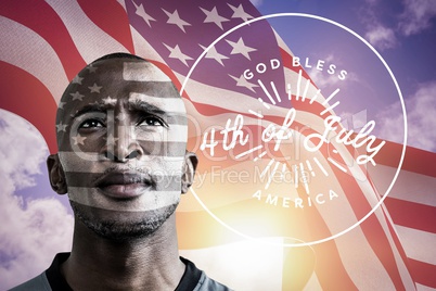 Black man with american flag fluttering in the wind on background