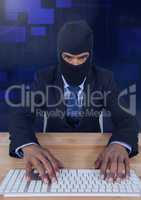 Hacker taping on keyboard on wood table