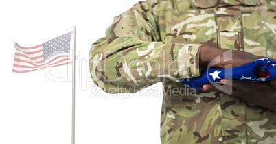 Soldier holding the american flag in front of white background