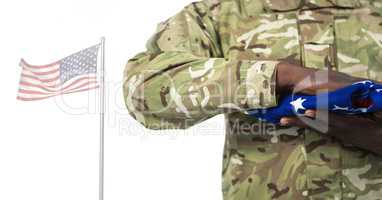 Soldier holding the american flag in front of white background
