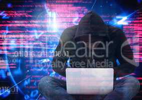Hacker with legs crossed using a laptop in front of digital background