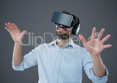 Man in virtual reality headset against grey background