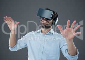Man in virtual reality headset against grey background