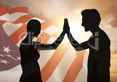 People shadow high fiving against american flag