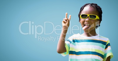 Boy in sunglasses making peace sign against blue background