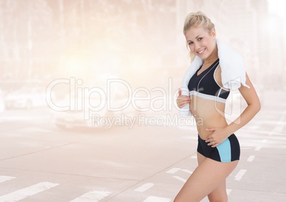 Sporty woman standing on a city background