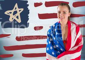 Woman wrapped in american flag against hand drawn american flag and blurry blue background