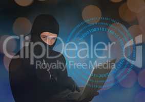 Hacker with hood using a laptop in front of digital background