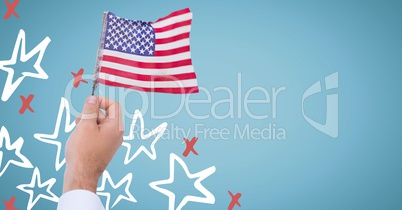 Hand holding american flag against blue background with hand drawn star pattern