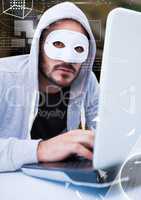 Hacker with a mask using a laptop