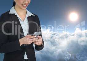 Smiling woman texting in 3D cloudy background