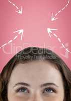 Woman looking up at white arrows against pink background