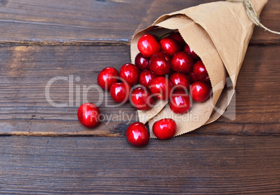 Red ripe cherry in a paper bag