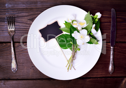 White round plate with iron knife and fork