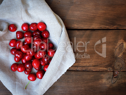 Ripe sweet cherry on a gray tablecloth