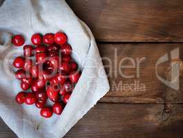 Ripe sweet cherry on a gray tablecloth