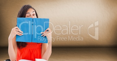 College student with blue book against brown background