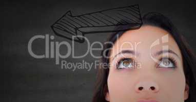 Top of woman\'s head looking at 3d grey arrow against grey wall