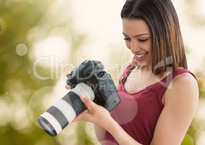 photographer woman smiling with green blurred lights