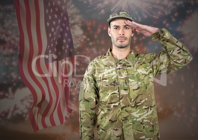 Proud soldier saluting against fluttering american flag and fireworks in background