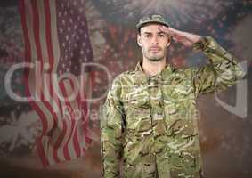 Proud soldier saluting against fluttering american flag and fireworks in background