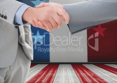 Business people shaking their hands against american flag