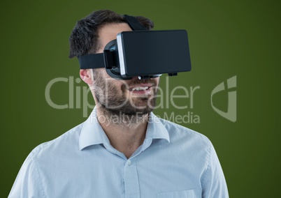 Man in virtual reality headset against green background
