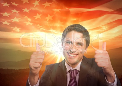 Happy business man with thumbs up against sunset and american flag