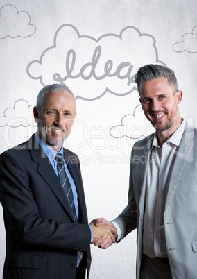 Business men shaking hands against white wall with idea doodles