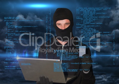 Hacker working on laptop in front of blue digital background