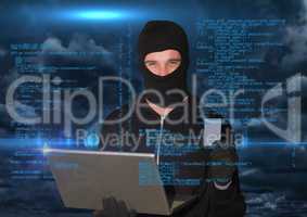 Hacker working on laptop in front of blue digital background