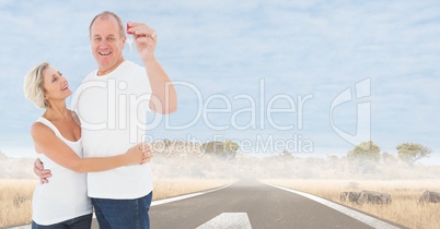 Couple Holding Keys with road