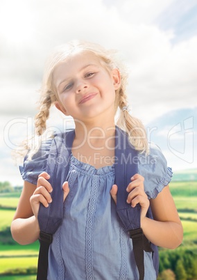 Schoolgirl against fields with flare