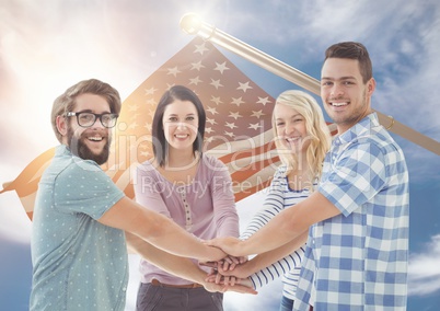 Happy friends putting their hands together with a 3D fluttering american flag in background