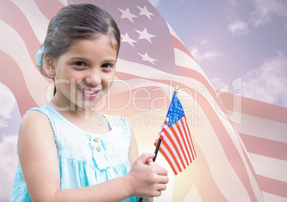 Smiling girl holding an american flag for independence day