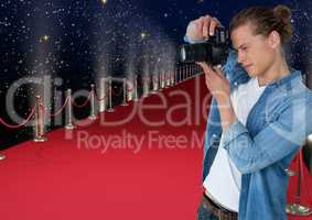3d photographer taking a photo  in the red carpet. Lights and stars back