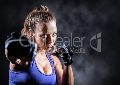 Female boxer against mist