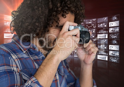 photograph taking picture with his camera against screens