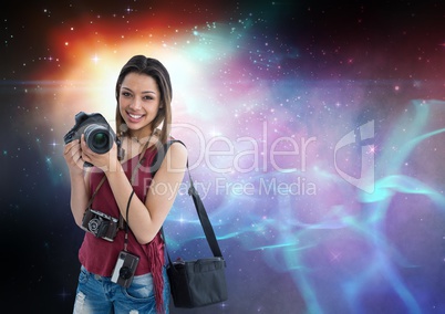 Photographer holding camera  against galaxy background