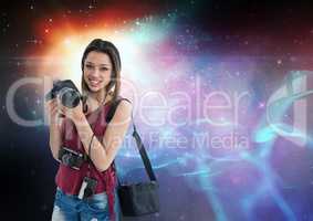 Photographer holding camera  against galaxy background