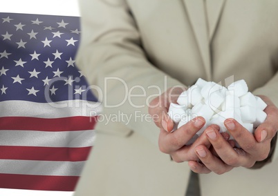 Man holding piece of paper in his hands against american flag