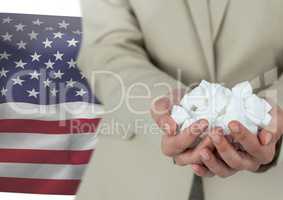 Man holding piece of paper in his hands against american flag