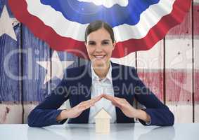 Business woman covering a house against american flag