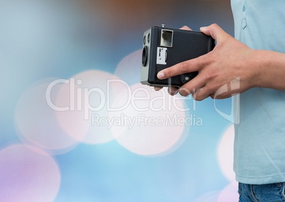 Part of a photographer holding a camera