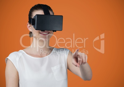 Woman in virtual reality headset against orange background