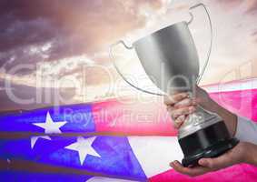 Part oh a man holding a cup against fluttering american flag